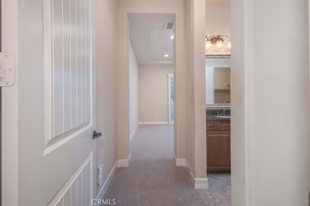 1647 Via Rojas Hemet, CA 92545 - Photo 14 of 29 a view of a hallway with wooden floor and a bathroom