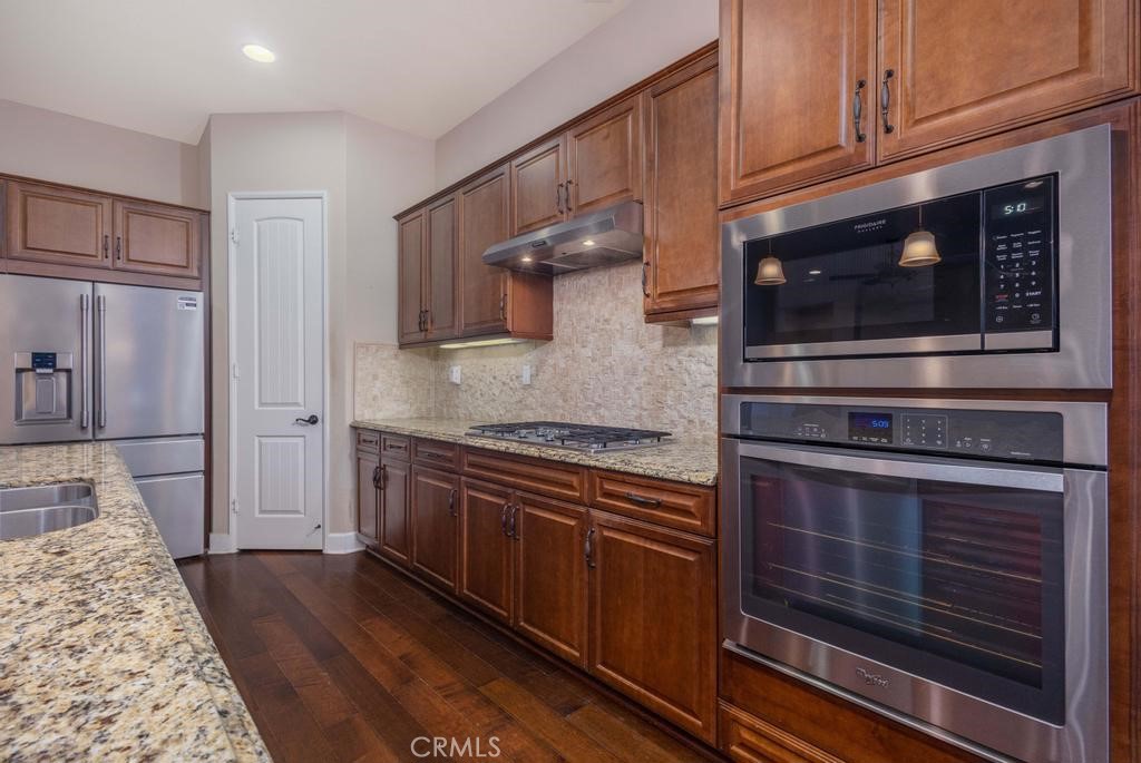 1647 Via Rojas Hemet, CA 92545 - Photo 5 of 29 a kitchen with stainless steel appliances granite countertop a stove microwave and cabinets