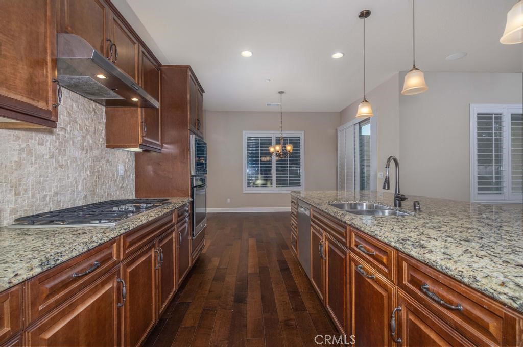 1647 Via Rojas Hemet, CA 92545 - Photo 6 of 29 a kitchen with kitchen island a sink stove and wooden floor