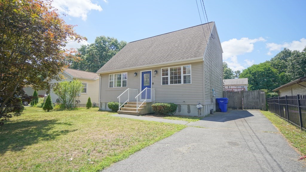 142 Avery Street Springfield, MA 01119 - Photo 1 of 27 a front view of a house with a yard and garage
