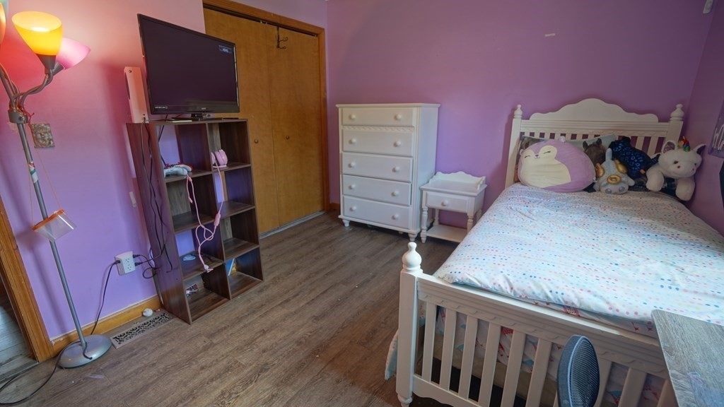 142 Avery Street Springfield, MA 01119 - Photo 16 of 27 a bedroom with a bed and wooden floor
