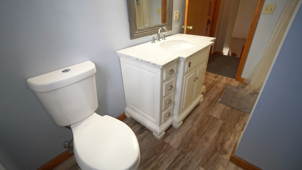 142 Avery Street Springfield, MA 01119 - Photo 17 of 27 a bathroom with a toilet sink and mirror