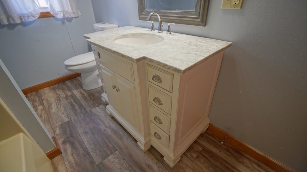 142 Avery Street Springfield, MA 01119 - Photo 18 of 27 a bathroom with a granite countertop sink toilet and a mirror