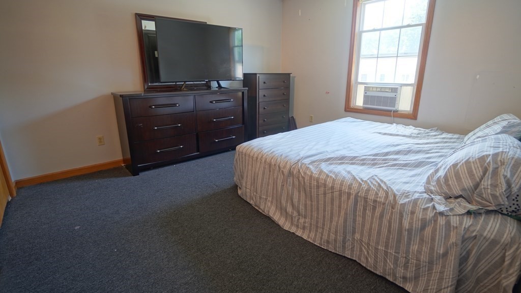 142 Avery Street Springfield, MA 01119 - Photo 19 of 27 a bedroom with a bed and a flat tv screen on dresser