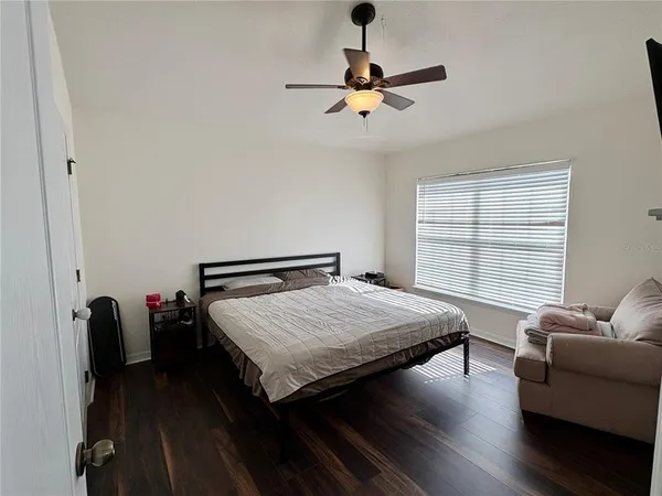 a bedroom with bed and window