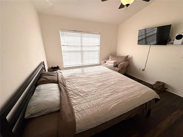 a bed sitting in a bedroom next to a window