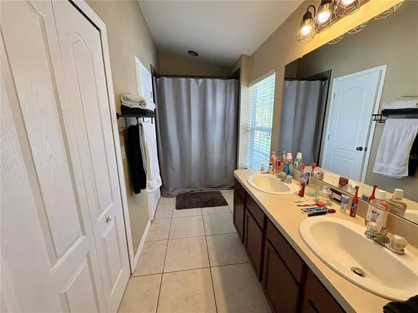 a bathroom with a double vanity sink and a mirror