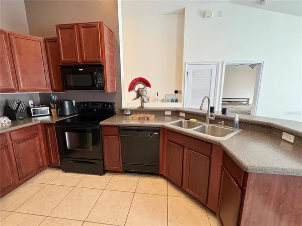 a kitchen with a sink stove and microwave