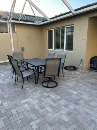 a view of a balcony dining table and chairs with wooden floor