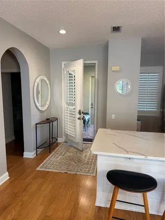 a bedroom with a bed a dresser and chair