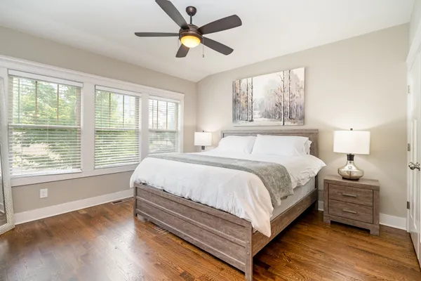 a bedroom with a large bed and a large window