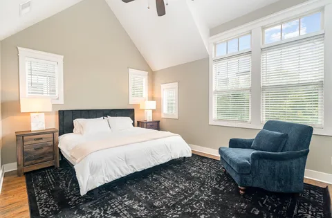 a bedroom with bed couch and window