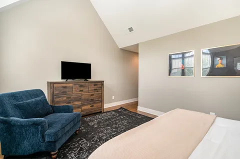 a bedroom with furniture and a flat screen tv