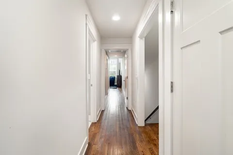a view of hallway with wooden floor