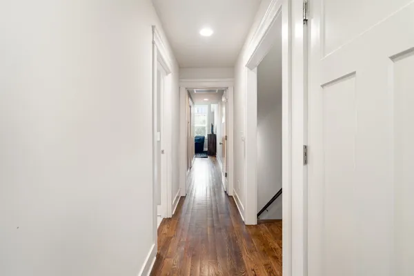 a view of hallway with wooden floor