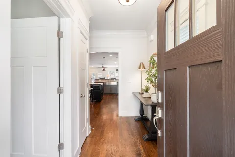 a view of a hallway and a livingroom with furniture