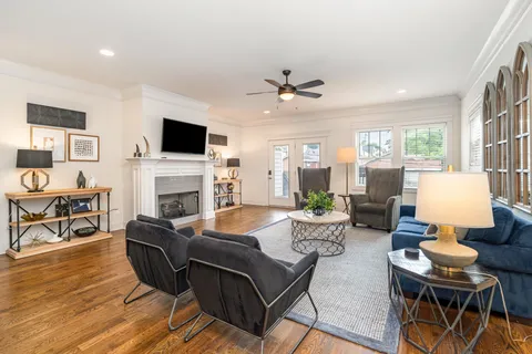 a living room with furniture a fireplace and a flat screen tv