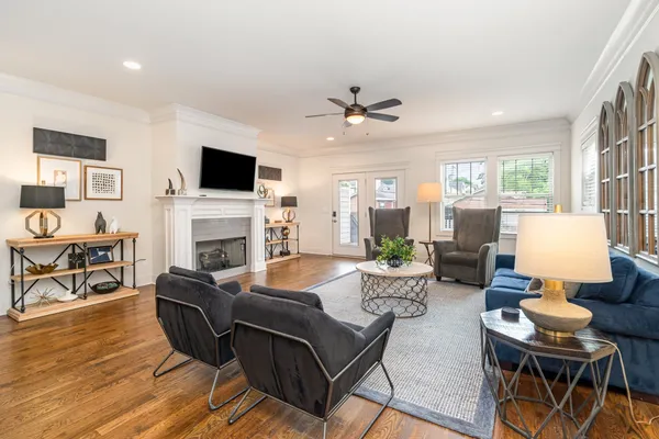 a living room with furniture a fireplace and a flat screen tv