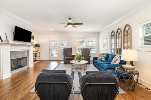 a living room with fireplace furniture and a flat screen tv