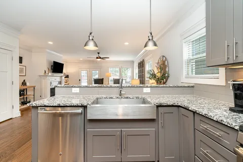 a kitchen with center island and windows