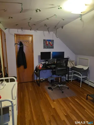 a bedroom with furniture and wooden floor