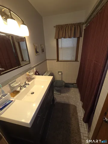 a bedroom with furniture and a rug