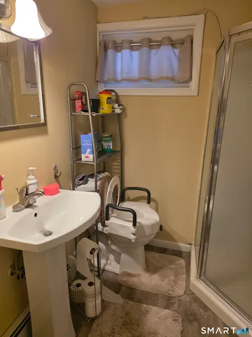 a bedroom with a bed gym equipment and a mirror