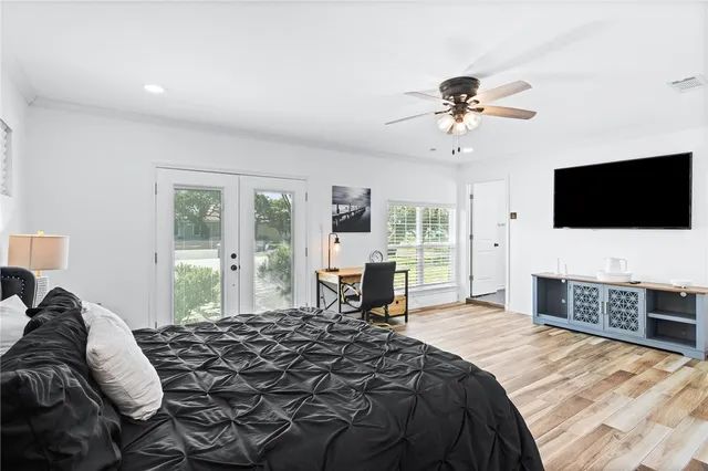 a bedroom with a bed and a flat screen tv