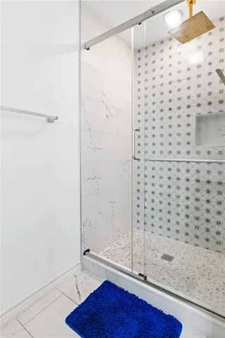 a bedroom with a bed window and a flat screen tv