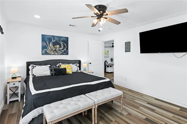 a bathroom with a toilet a sink a mirror a shower a vanity and window