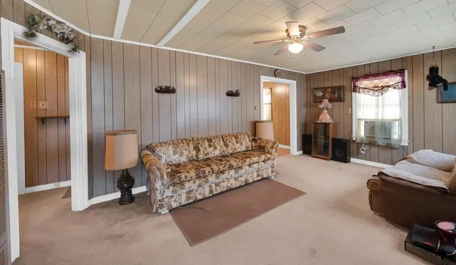 a spacious bedroom with a bed and a chandelier