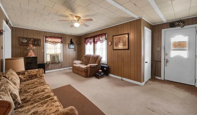 a living room with furniture and a chandelier