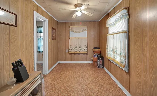 a view of a hallway with windows and chandelier