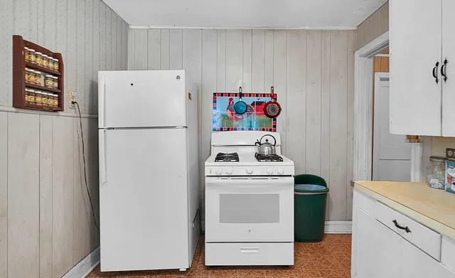 a white refrigerator freezer sitting inside of a kitchen