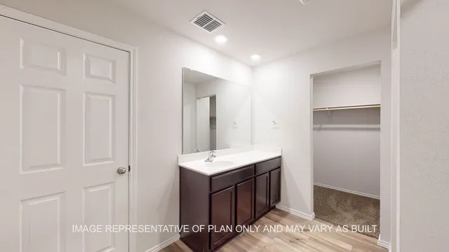 a bathroom with a sink vanity and a mirror