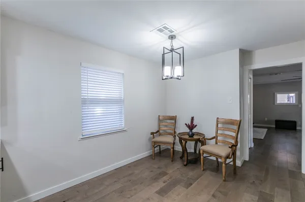 a view of a livingroom with furniture and chandelier