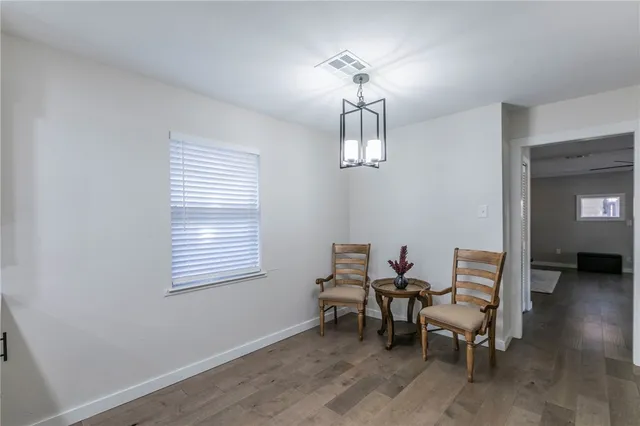 a view of a livingroom with furniture and chandelier