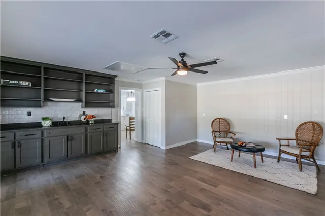 a kitchen with a refrigerator and wooden cabinets