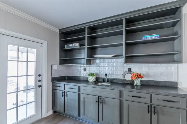 a kitchen with stainless steel appliances a cabinets and a window