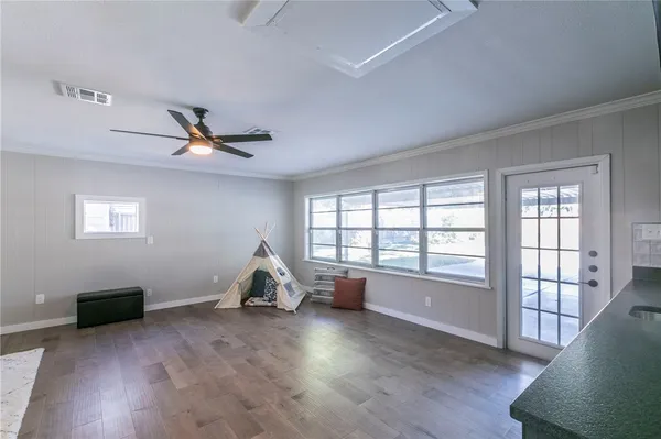 a living room with hardwood floor and a window