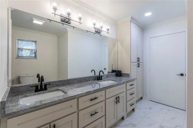 a bathroom with a granite countertop sink a mirror and a