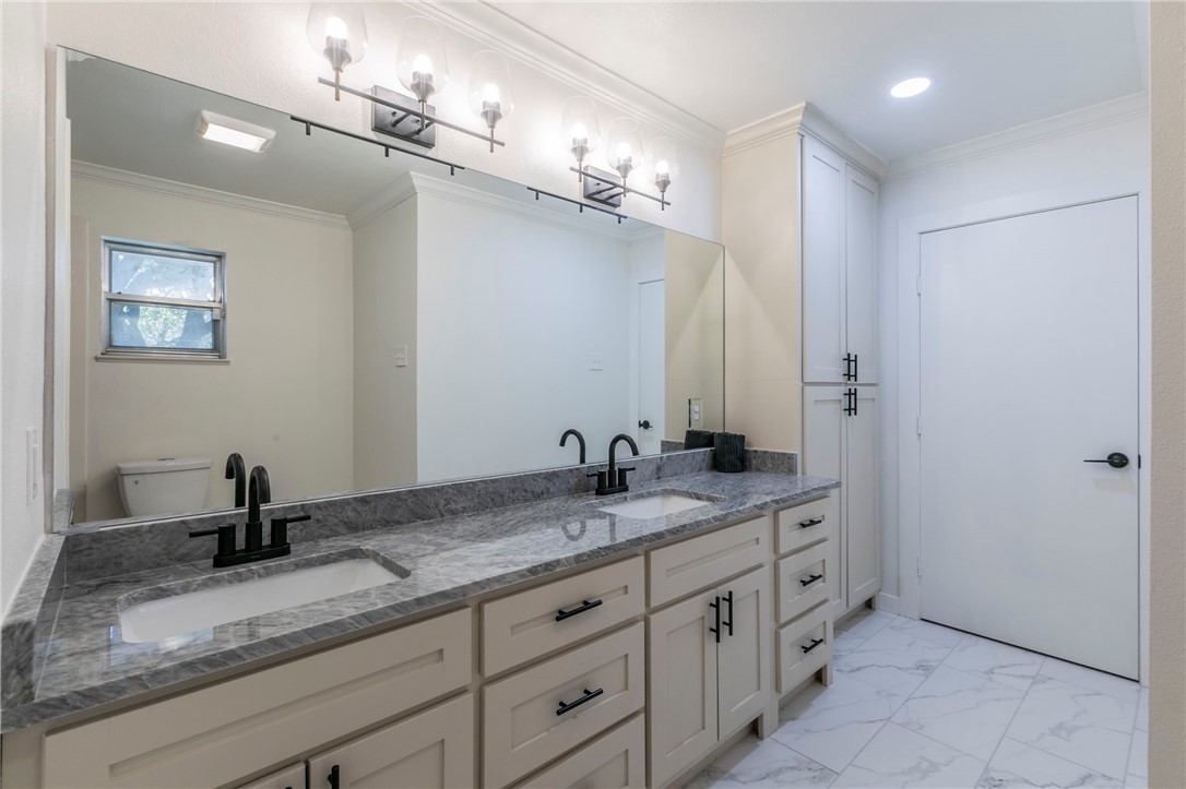 3401 Oakridge Lane Waco, TX 76708 - Photo 17 of 28 a bathroom with a granite countertop sink a mirror and a