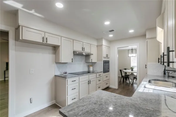 a kitchen with a sink and cabinets