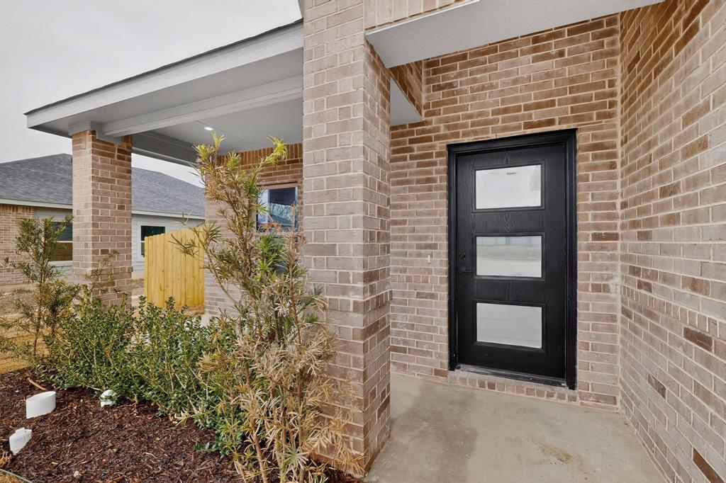 10185 Budtime Lane Dallas, TX 75217 - Photo 4 of 34 a front view of a house with garden