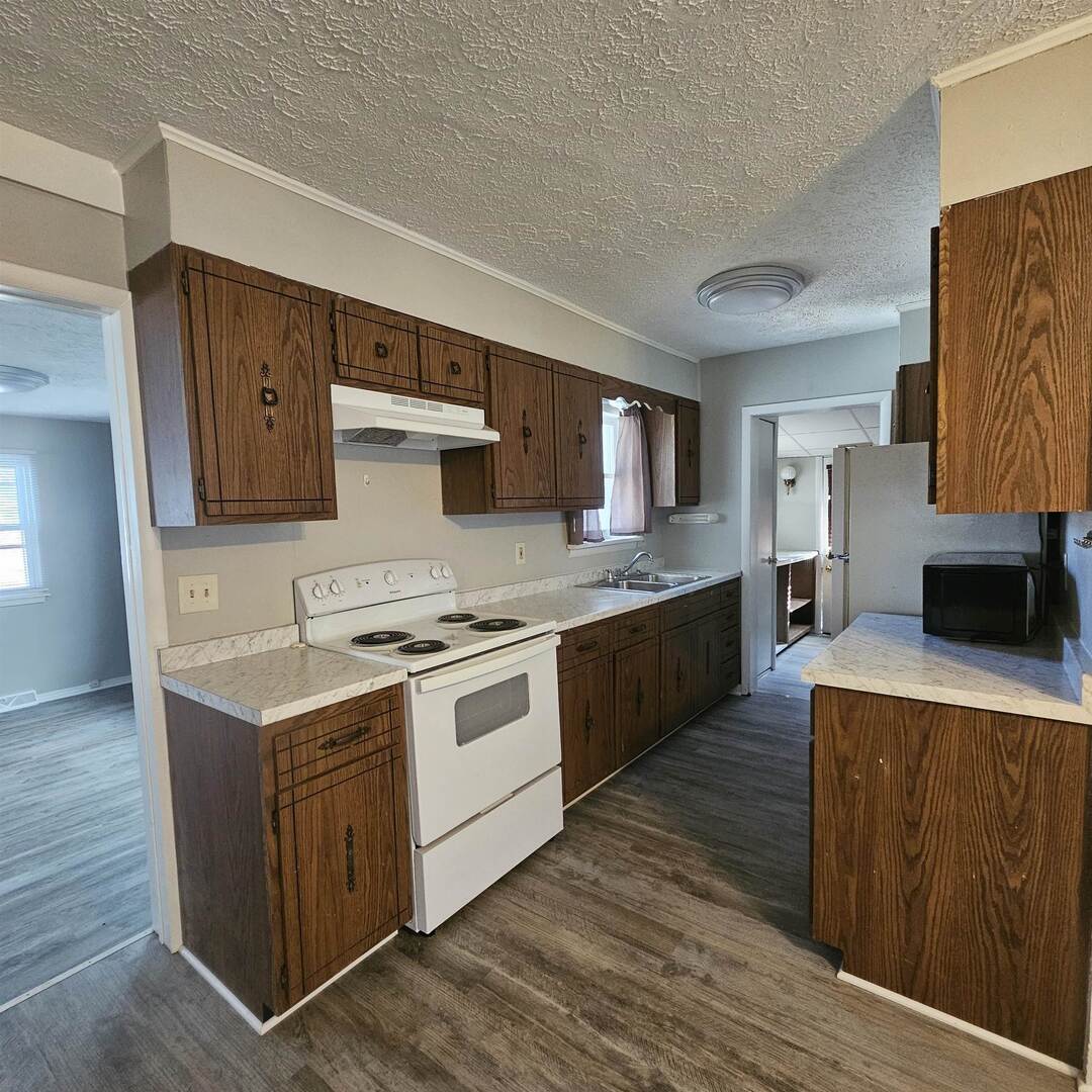 609 Airport Road Mount Vernon, IL 62864 - Photo 16 of 27 a kitchen with stainless steel appliances granite countertop a stove a sink and a refrigerator