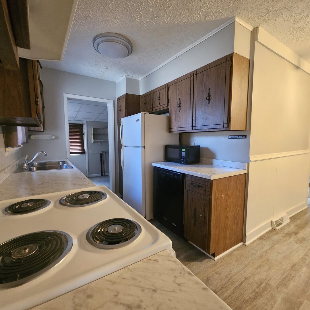 609 Airport Road Mount Vernon, IL 62864 - Photo 17 of 27 a kitchen with a refrigerator and a sink
