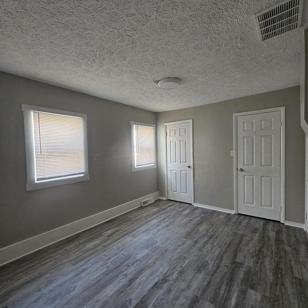 609 Airport Road Mount Vernon, IL 62864 - Photo 22 of 27 a view of an empty room with wooden floor and a window