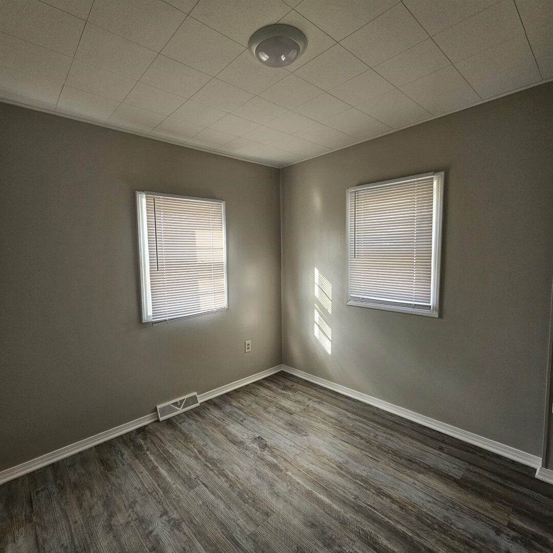 609 Airport Road Mount Vernon, IL 62864 - Photo 23 of 27 an empty room with wooden floor and windows