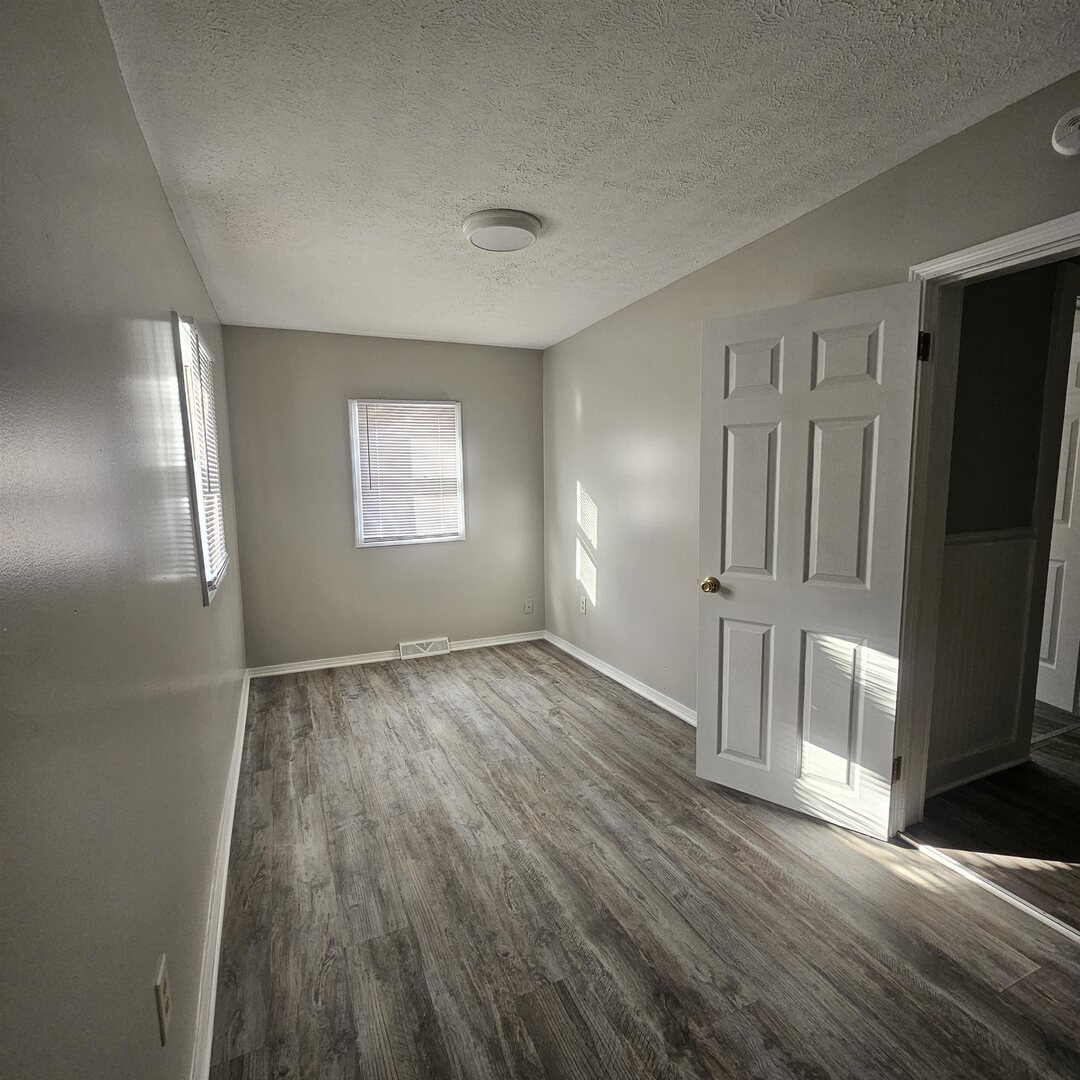 609 Airport Road Mount Vernon, IL 62864 - Photo 24 of 27 a view of empty room with wooden floor and fan