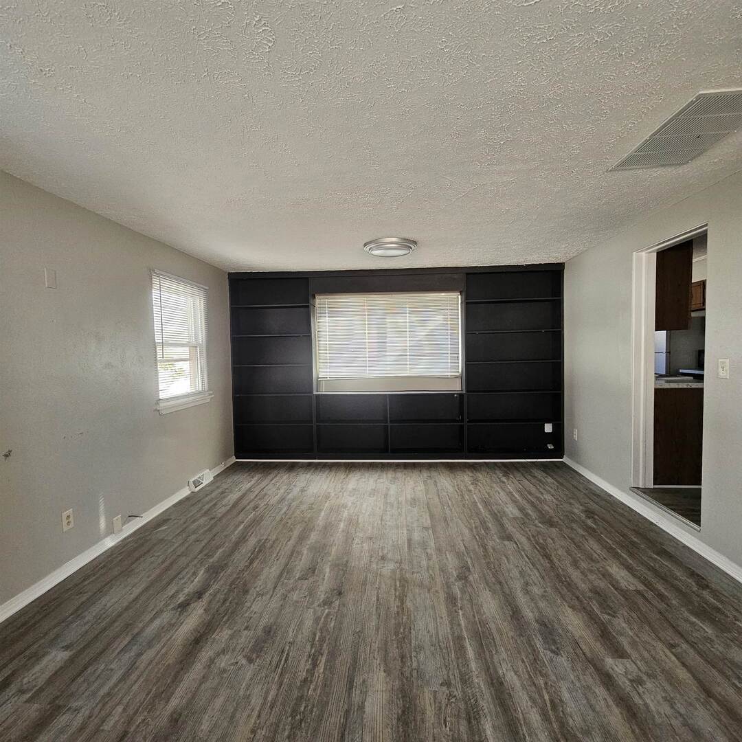 609 Airport Road Mount Vernon, IL 62864 - Photo 10 of 27 a view of an empty room with wooden floor and a window